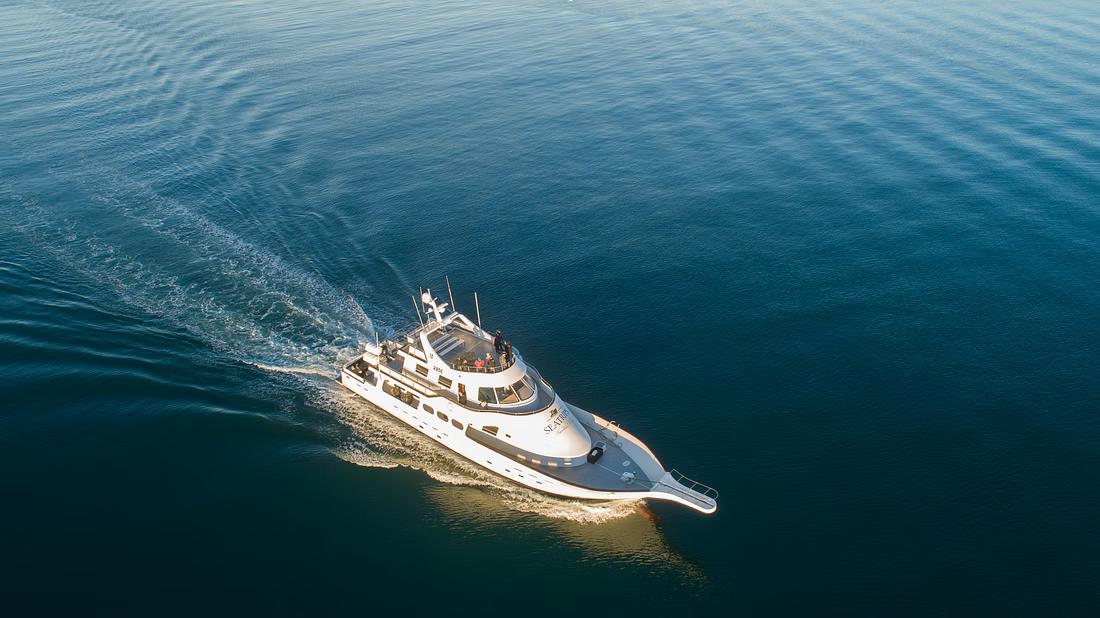 An aerial shot of a yacht at sea