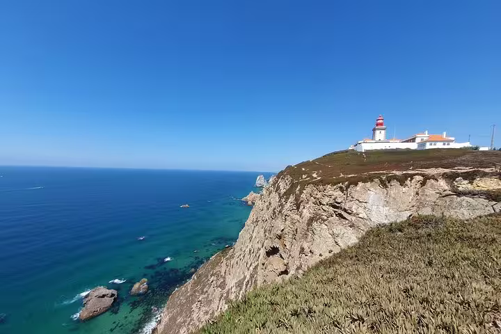 Breathtaking view of Cabo da Roca's rugged cliffs and iconic lighthouse on the Sintra and Cascais private full-day tour.
