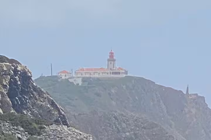 Scenic view of Cabo da Roca lighthouse perched on cliffs along the Sintra-Cascais Jeep Tour.