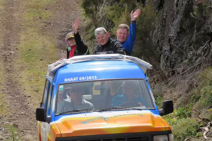 Adventurers enjoy a thrilling 4x4 ride on a scenic trail during the Cabo Girão Skywalk and vineyard exploration tour.
