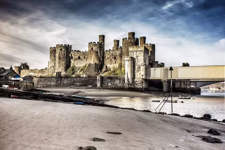 Caernarfon Castle by the Menai Strait and bridge, key stop on the Snowdonia & The 3 Castles Tour