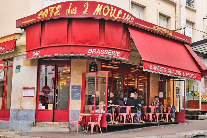 Charming view of Café des 2 Moulins in Montmartre, a highlight in the Paris private full day tour with Eiffel Tower visit.