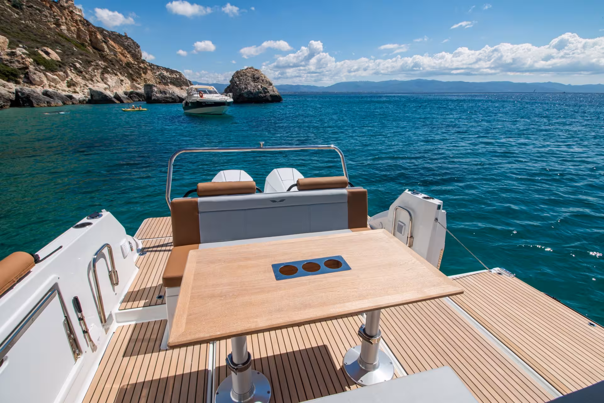 Scenic view from boat's dining area overlooking Cagliari's turquoise waters and rocky coastline on a 3-hour cruise.