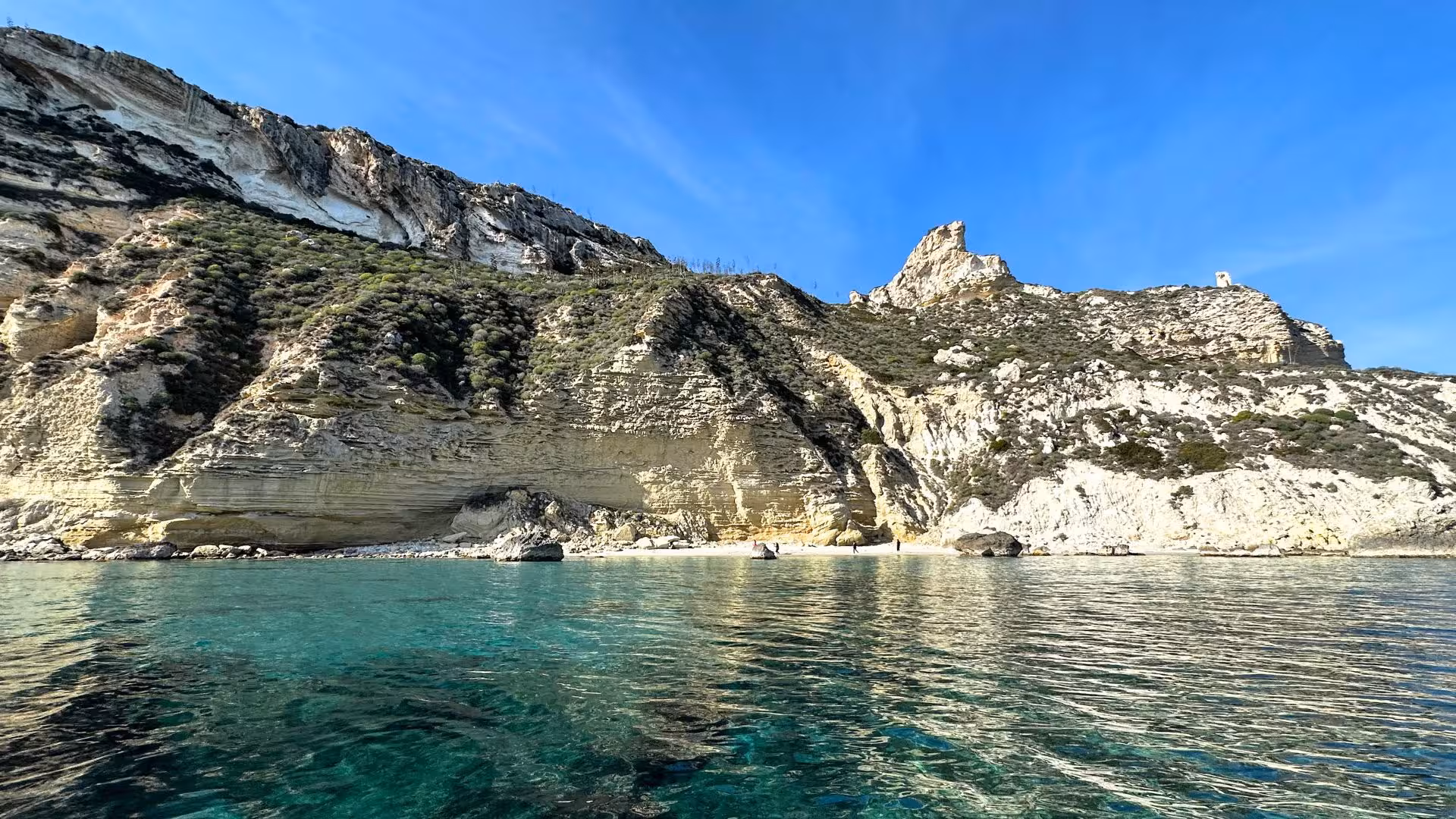 Stunning rocky cliffs and clear blue waters in Cagliari, perfect for a boat tour with snorkeling adventures.