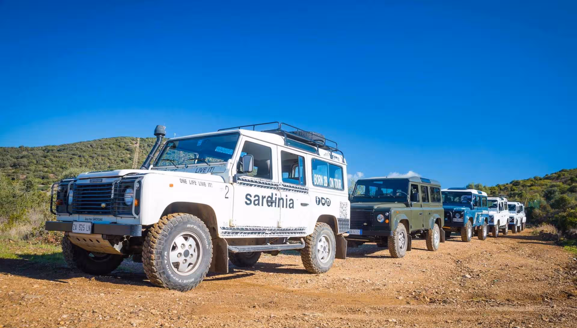 Line of jeeps on a rugged dirt path during the adventurous Cagliari to Chia tour in Sardinia.