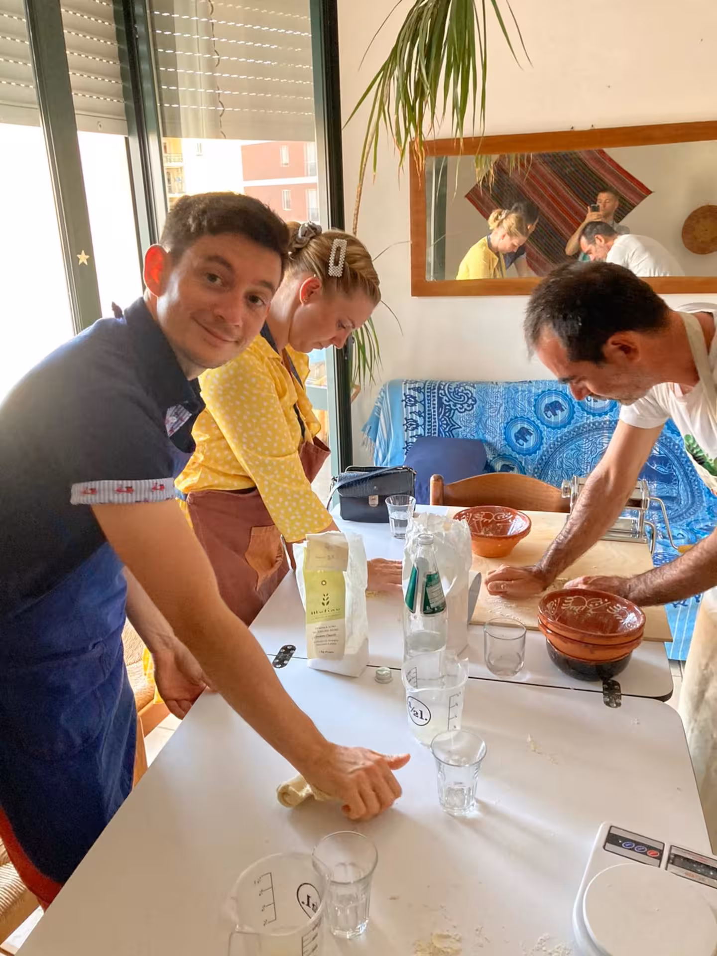 Participants enjoy making culurgiones pasta in an engaging cooking class in Cagliari, Sardinia.