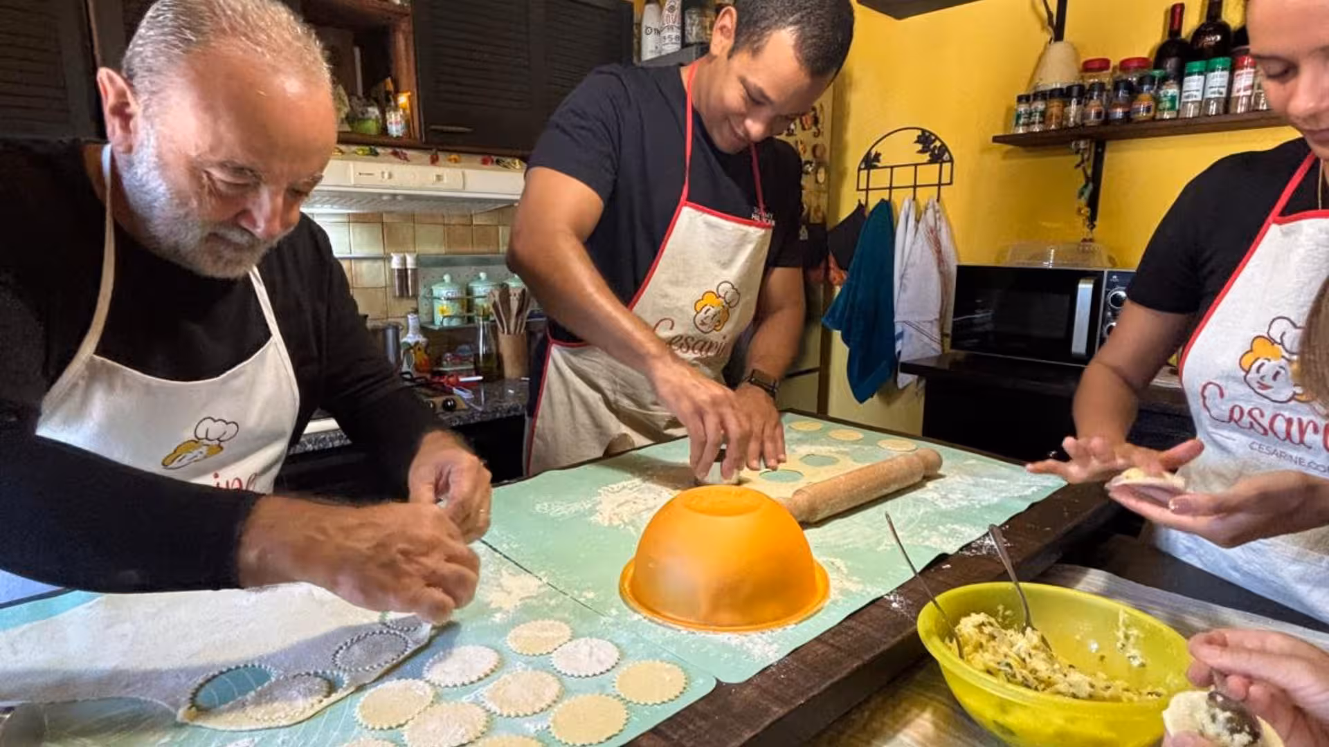 Enthusiastic group creating authentic culurgiones during a hands-on cooking class in Cagliari.