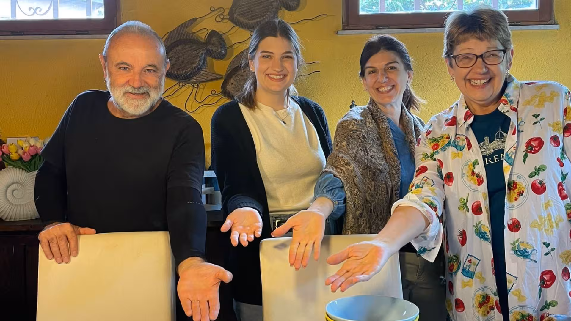 Participants smiling and presenting their handmade pasta at a Cagliari culurgiones cooking class.