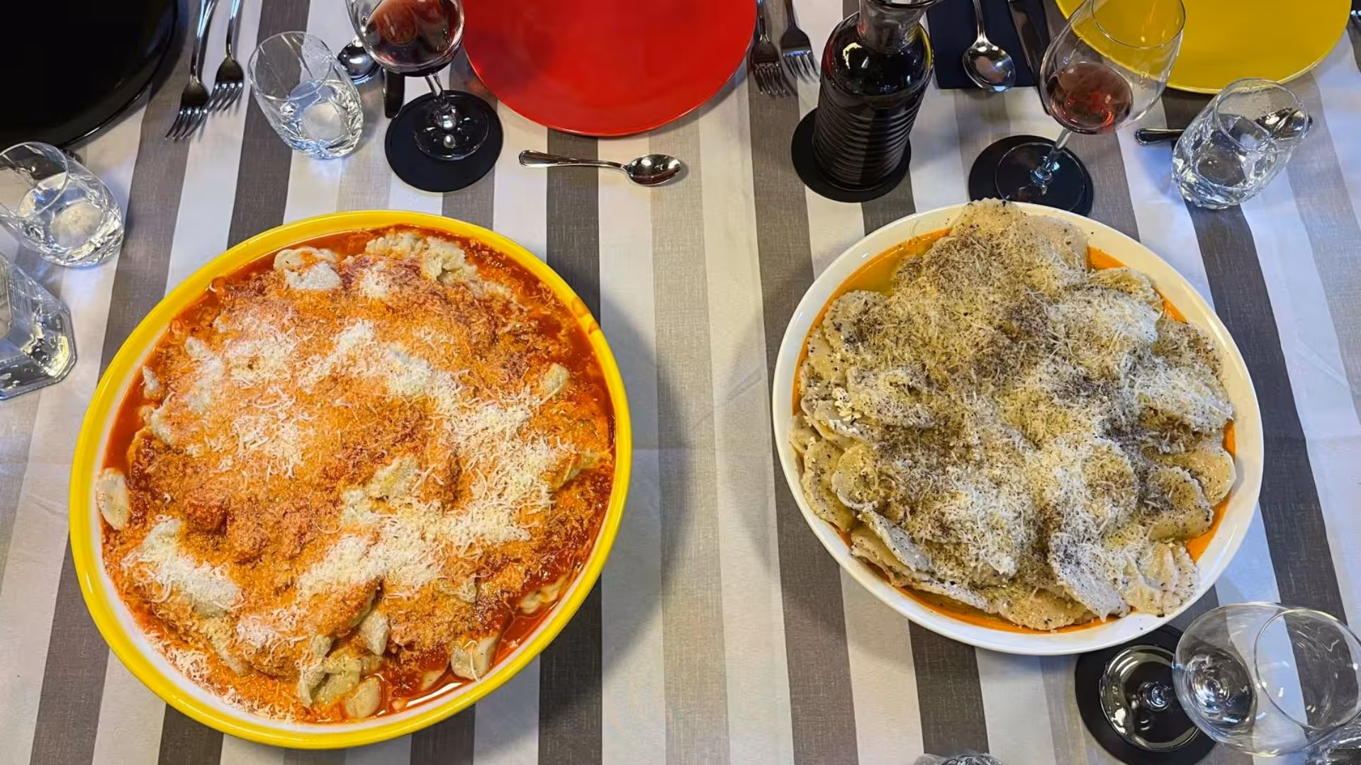 Two bowls of freshly prepared culurgiones with tomato and cheese, showcasing Cagliari's culinary tradition.