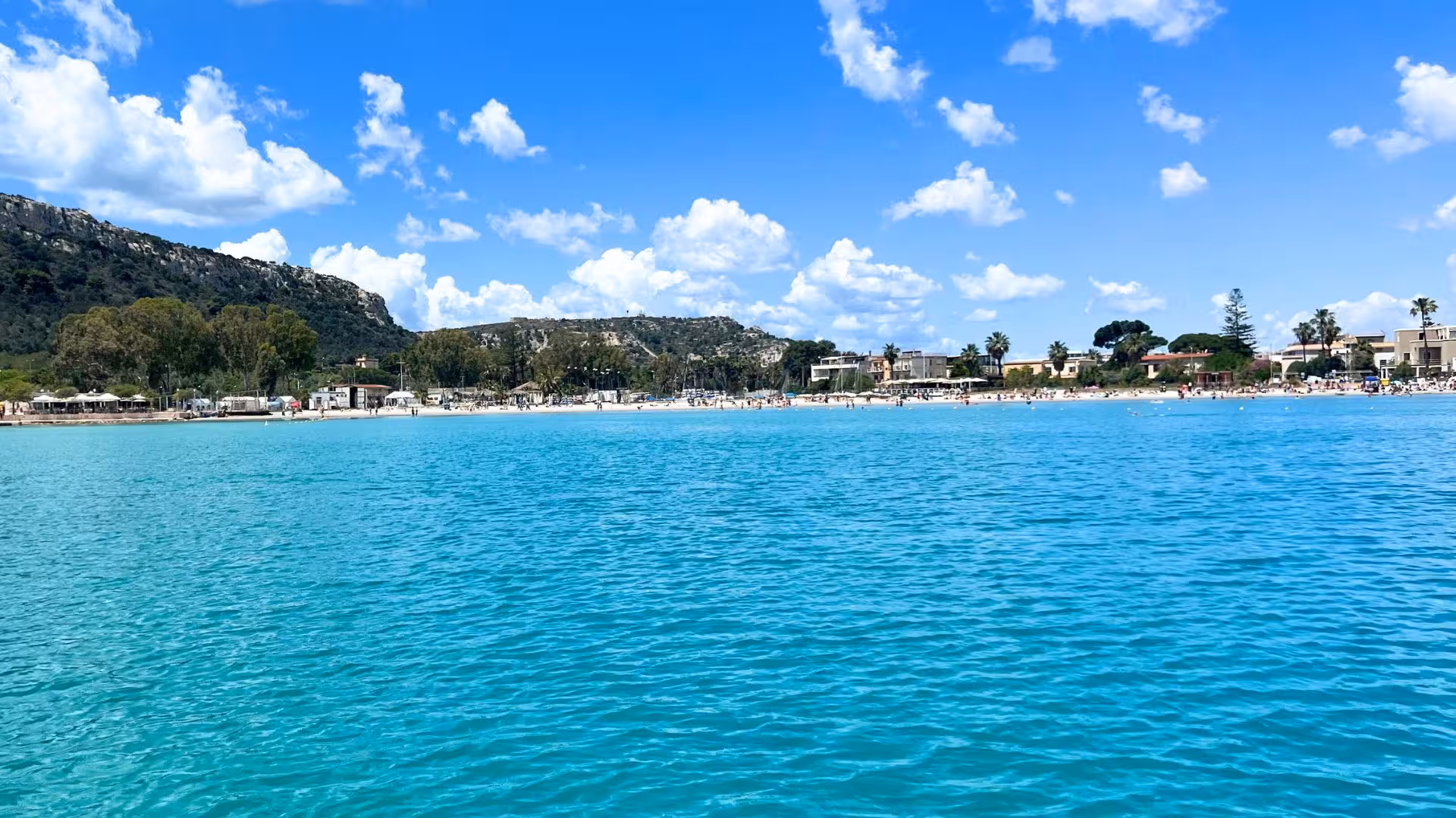 Stunning view of Cagliari's coastline with azure waters and vibrant beach.
