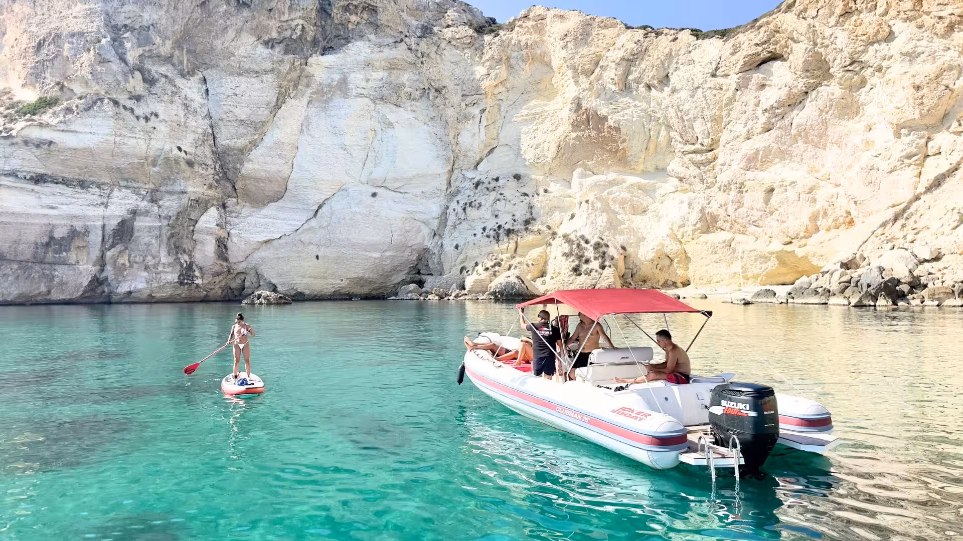 Scenic Cagliari dinghy tour with snorkeling near rocky cliffs and turquoise waters.
