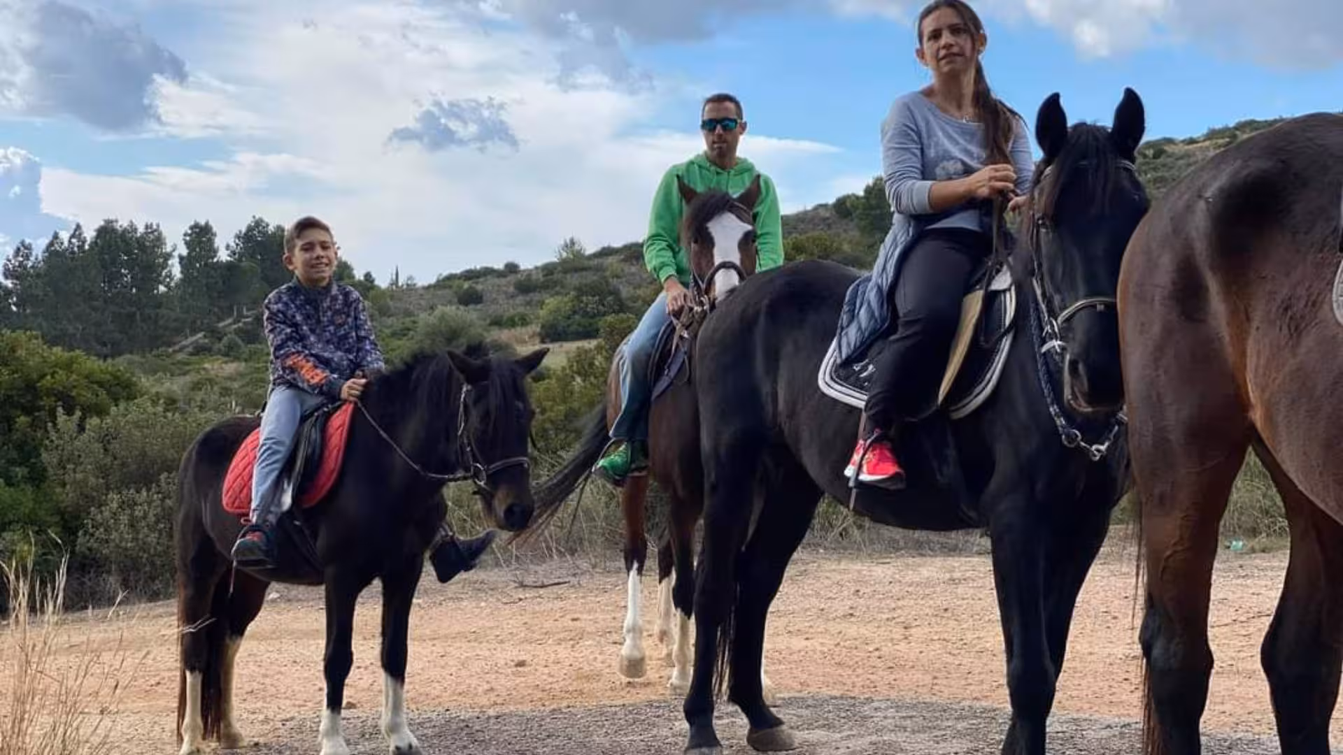 Family experiencing a panoramic horseback adventure in Cagliari, exploring beautiful landscapes together.