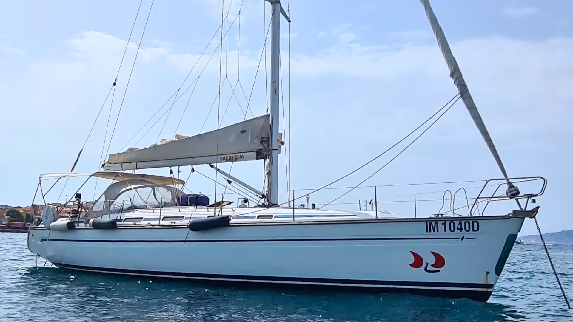 Elegant sailing boat anchored in the azure waters of Cagliari, offering a luxurious 5-hour sailing tour experience.