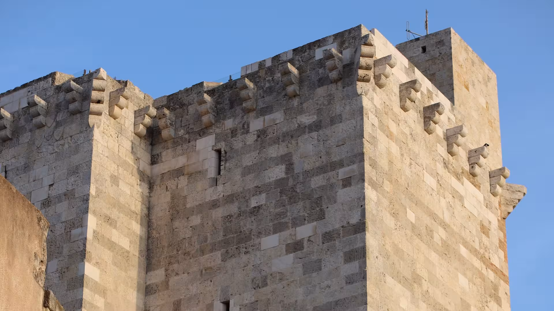 Historic stone tower in Cagliari's center, highlighting medieval architecture on a food and wine tour of Sardinia.