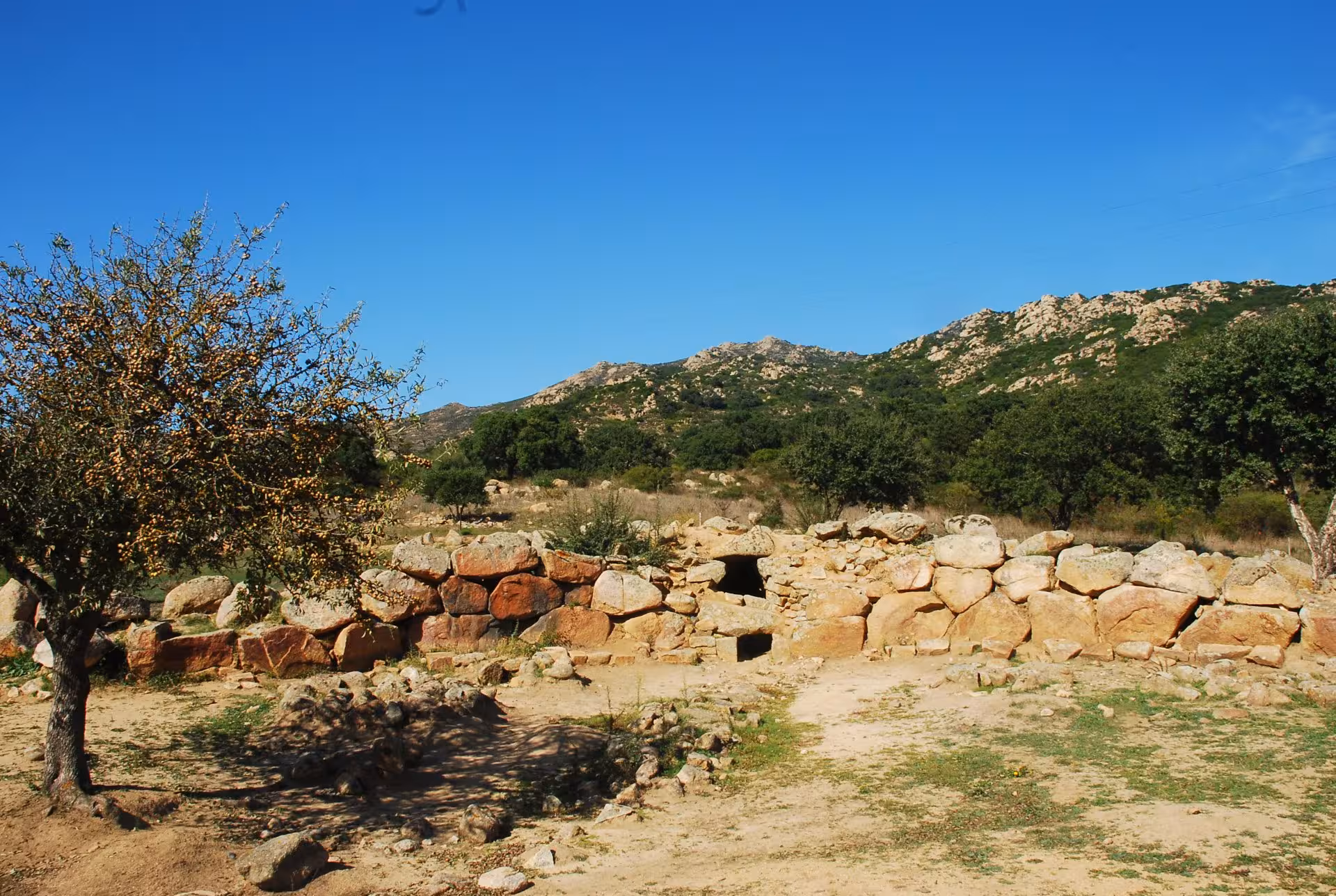 Explore ancient stone structures amid lush hills on the Cagliari mines and dunes tour in Piscinas.