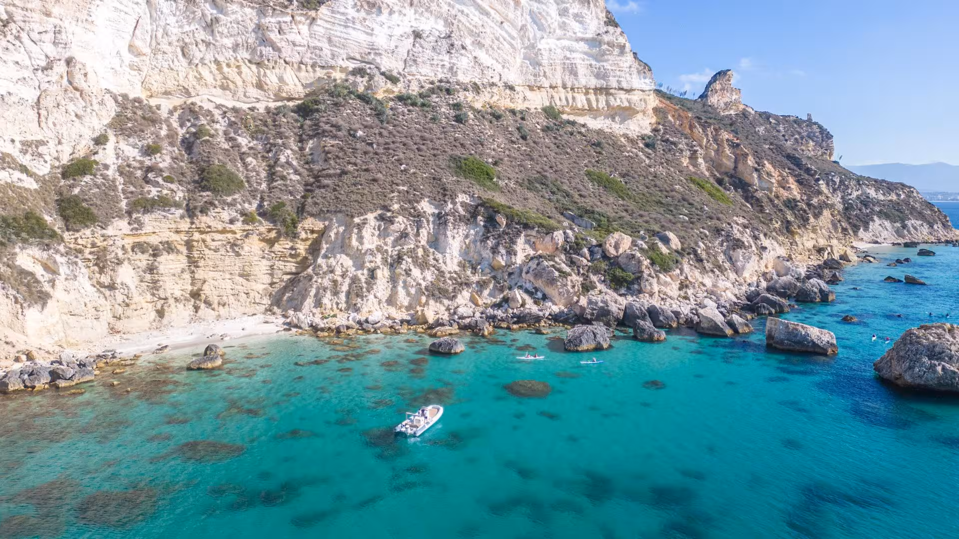 Scenic RIB tour along the rugged coastline of Cagliari, showcasing clear waters and stunning rock formations.