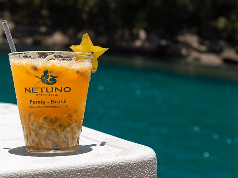 Refreshing caipirinha with starfruit garnish on a boat in Paraty, Brazil, perfect for a tropical escape.