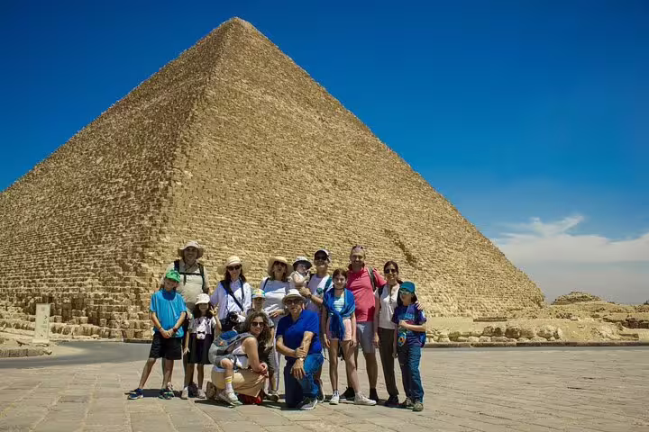 Tour group at the Great Pyramid of Giza under blue sky on a Cairo 3-day highlights tour in Egypt
