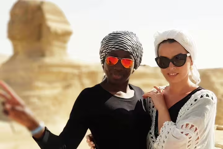 Tourists posing near the Great Sphinx of Giza on Cairo to Abu Simbel 8 days 7 nights road tour