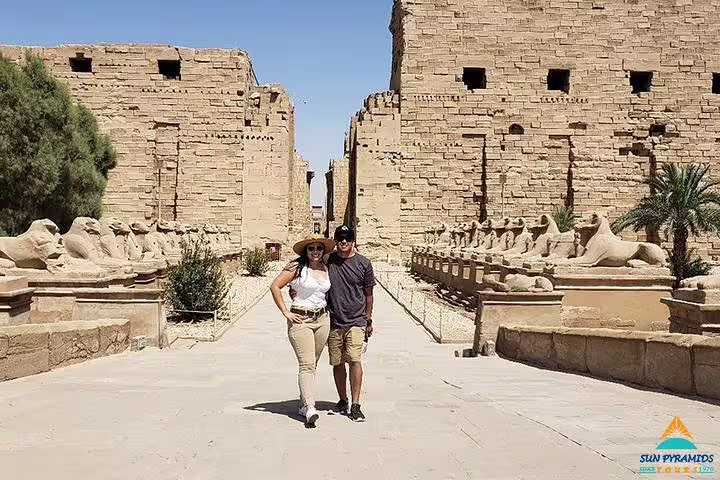 Couple walking the sphinx avenue at Karnak Temple, Luxor on an 8 days 7 nights Cairo to Abu Simbel road trip