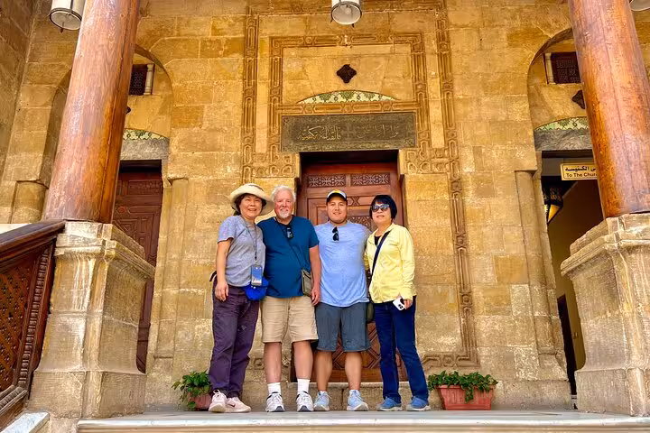 Group at Coptic Cairo church entrance on private Cairo Airport tour with Egyptian Museum and pyramids visit