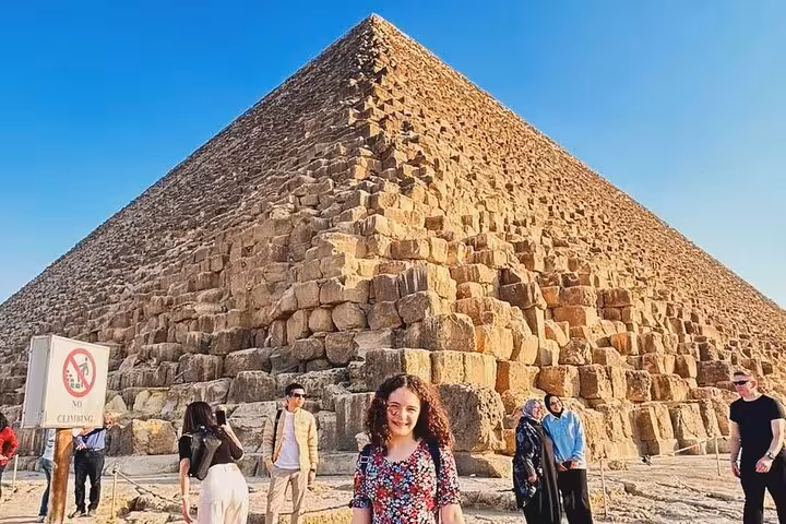 Tourists at the Great Pyramid of Giza on a private Cairo Airport transfer tour to pyramids and museum