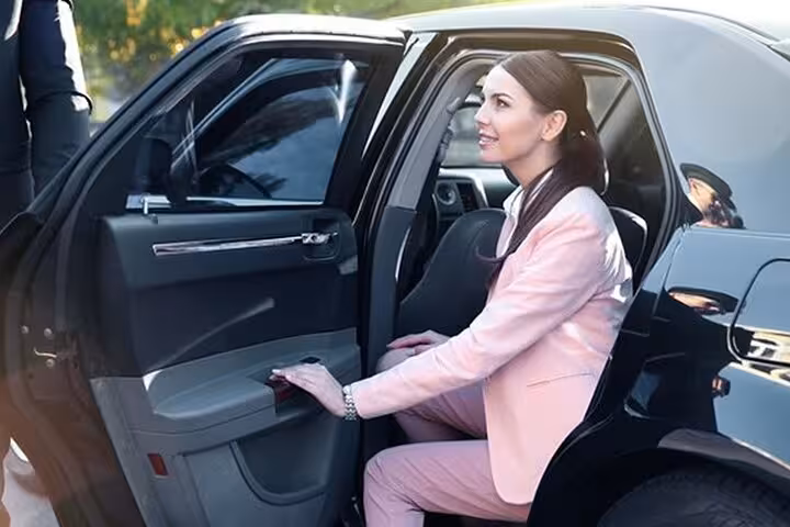 Traveler boarding a private car for Cairo International Airport transfer to Cairo or Giza with meet-and-greet