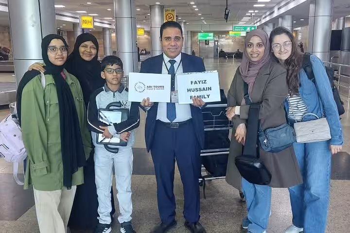 Family warmly welcomed at Cairo Airport by VIP meet and assist service, showcasing personalized travel support.