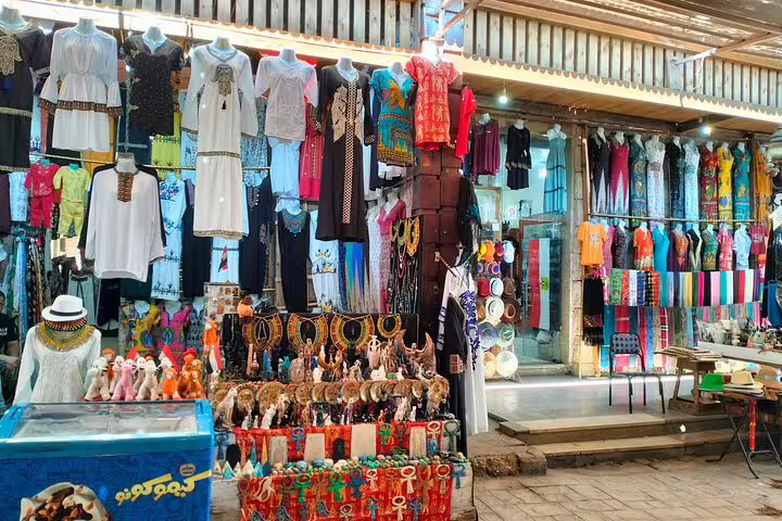 Colorful Cairo bazaar stall with Egyptian souvenirs, textiles and jewelry on a 7-day luxury Egypt tour