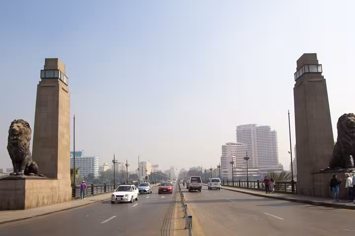 Cairo city bridge with lion statues and skyline, part of Hurghada to Cairo day trip and museum tour