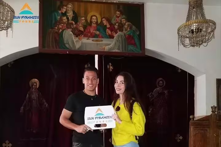 Tour guests inside Cairo Cave Church with Christian icons, part of City of the Dead and Coptic Cairo tour