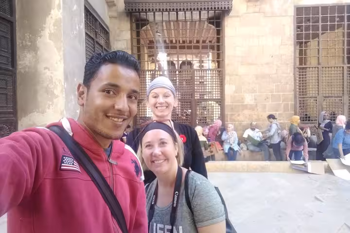 Travelers with local guide at Cairo Citadel courtyard, part of 2-day tour including bazaar and museums