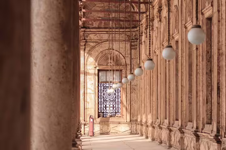 Historic corridor with hanging lamps and carved arches inside Cairo Citadel on Old Cairo private tour