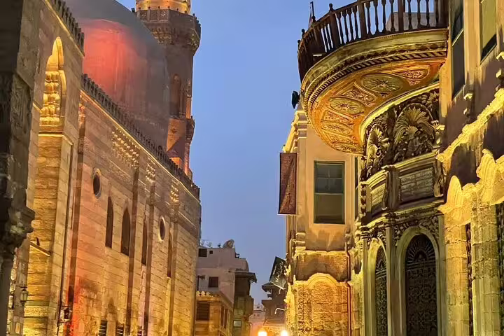 Historic Islamic Cairo street near Khan El-Khalili with ornate balcony and mosque dome on Cairo city tour
