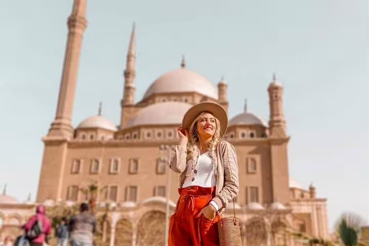 Traveler at Cairo Citadel with Mohamed Ali Mosque domes, a highlight of Cairo day tour itinerary