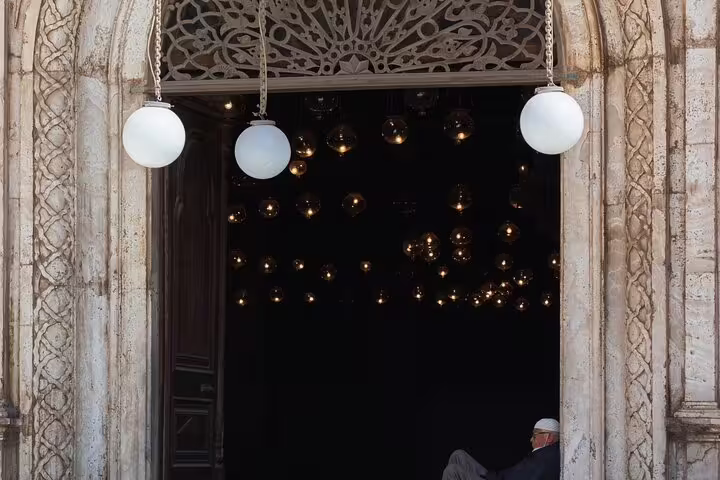 Ornate arched doorway at Cairo Citadel mosque with hanging lamps, featured on Cairo museum and citadel tour