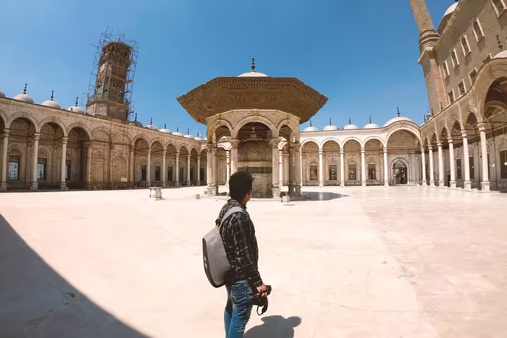 Traveler in Cairo Citadel mosque courtyard with ornate ablution fountain on Citadel, Bazaar and Mosques tour