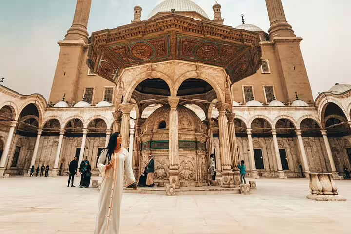 Traveler in Cairo Citadel courtyard by ornate mosque, part of National Museum to Citadel & Bazaars tour