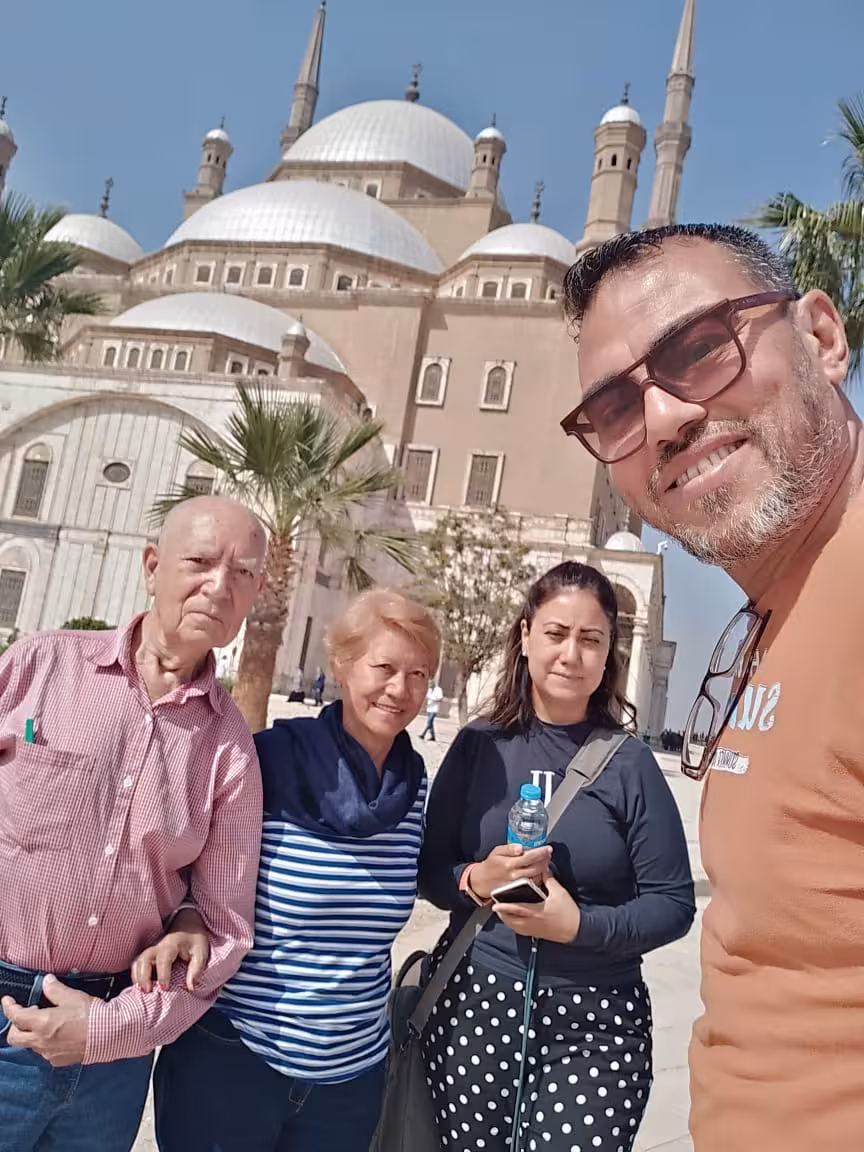 Travelers with guide at Cairo Citadel of Saladin, posing by Mosque of Muhammad Ali on a guided tour