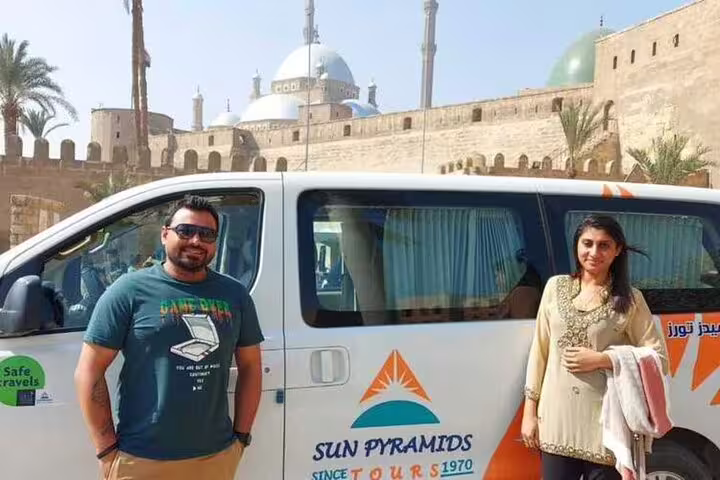 Tour van and travelers at Cairo Citadel near Mosque of Muhammad Ali on a 3-day Cairo highlights tour