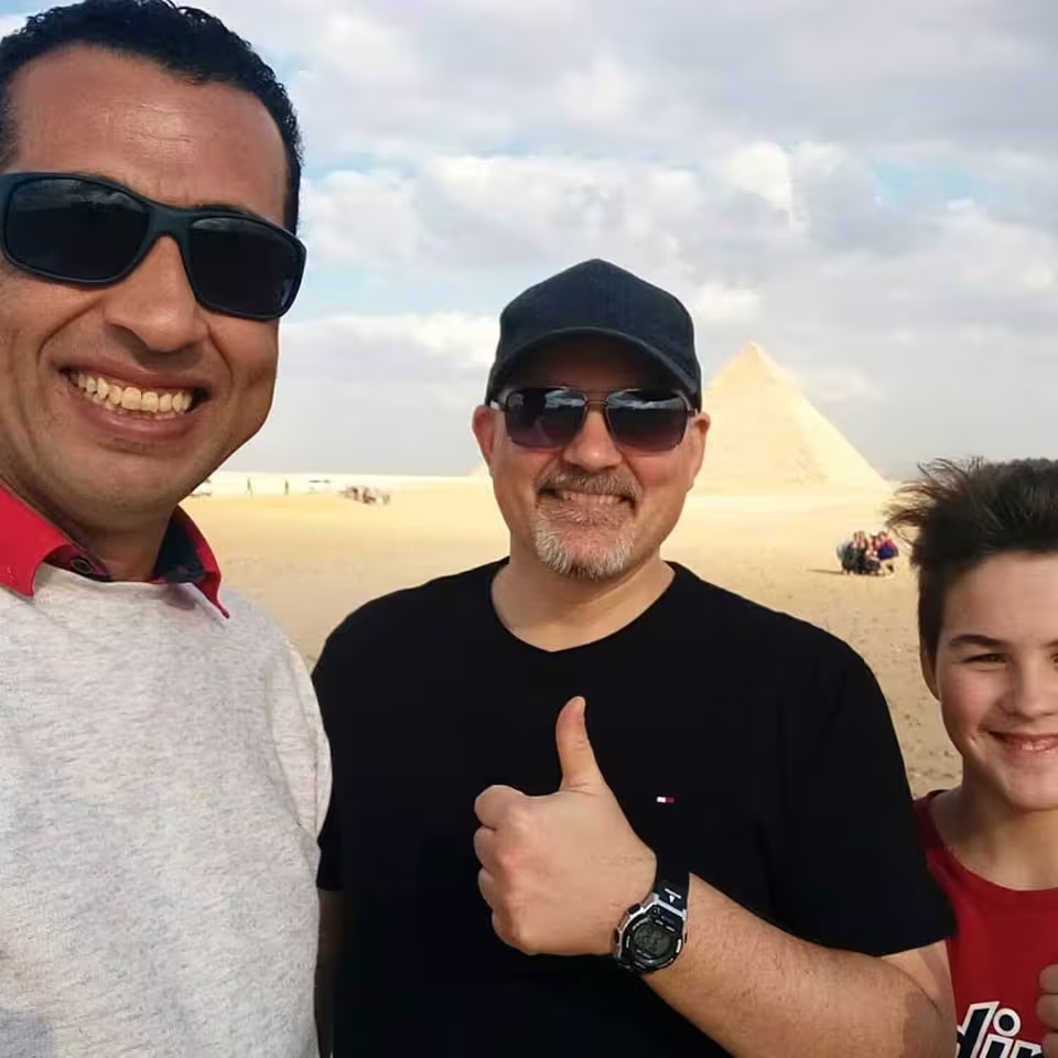 Private Cairo day tour by air from Sharm El Sheikh selfie at Giza Pyramids with guide and family