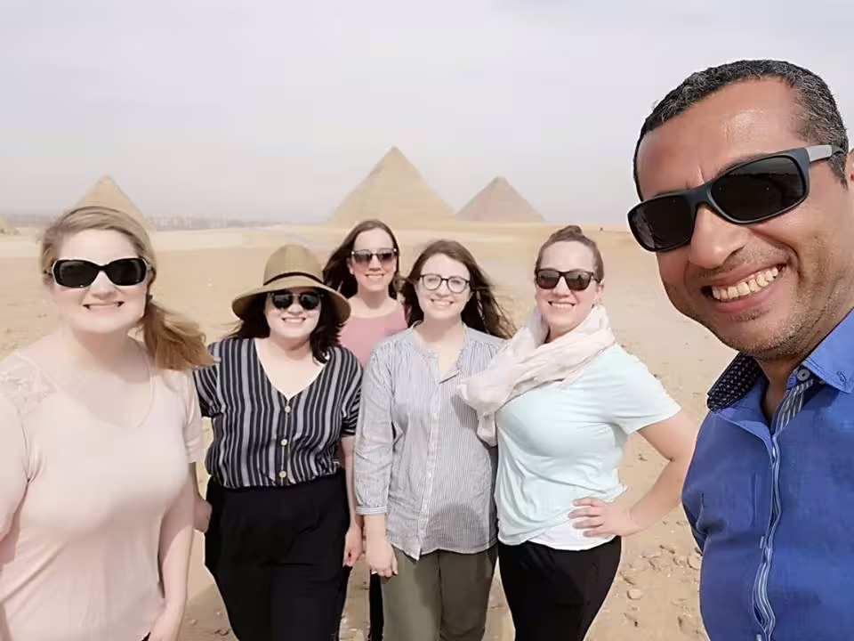 Group photo at Giza Pyramids on private Cairo day tour by air from Sharm El Sheikh with local guide