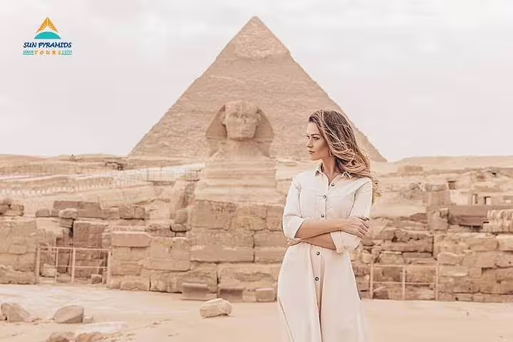 Traveler at the Great Sphinx and Giza Pyramids on a Cairo day tour from Luxor by flight, Egypt