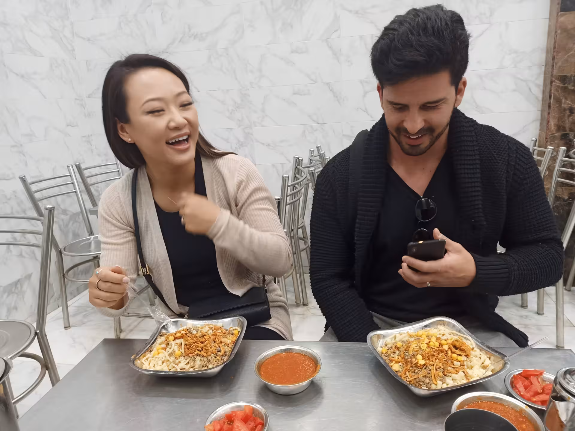 Couple enjoying Egyptian koshari and salsa at a Cairo restaurant on a private food tour walking adventure