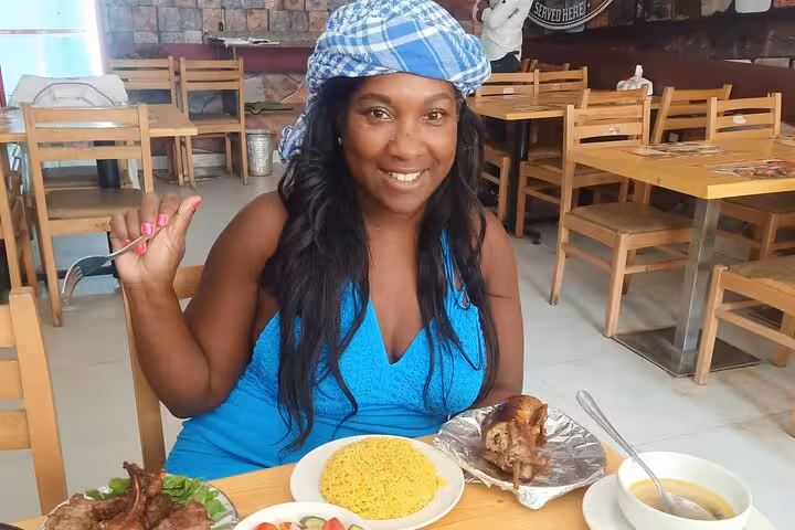 Smiling guest enjoying Egyptian rice and roasted meat at a Cairo restaurant on a private food walking tour