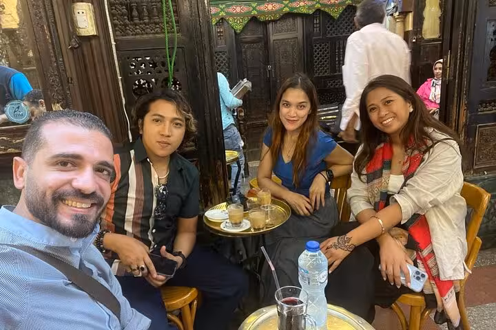 Group enjoying traditional Egyptian coffee at a historic Cairo café, part of a hidden gems culture and cuisine tour