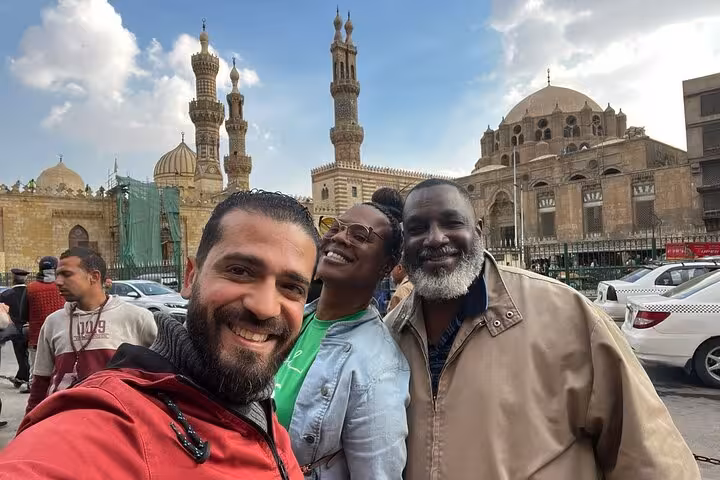 Travelers pose by Sultan Hassan and Al-Rifa’i mosques on a Cairo hidden gems culture and cuisine tour
