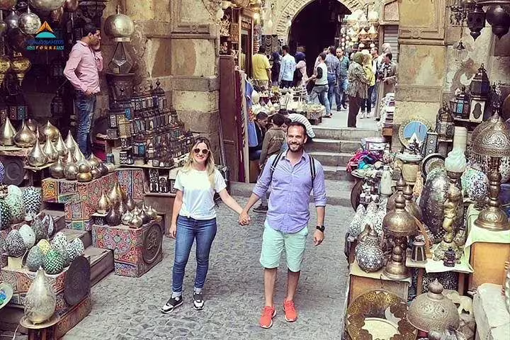 Couple exploring Khan El Khalili bazaar on Cairo full day tour from Alexandria by private car, shopping souvenirs