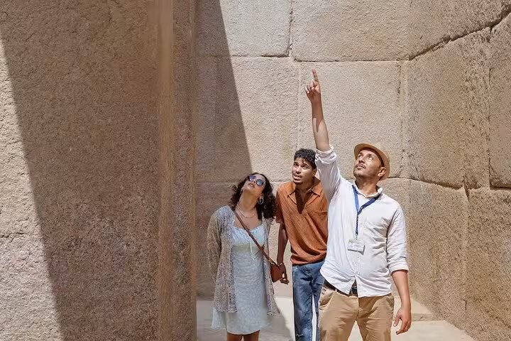 Private guide shows travelers ancient stone blocks at Giza Pyramid complex on Cairo airport layover tour