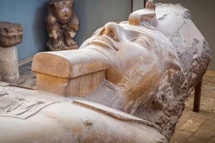 Ancient Egyptian limestone sarcophagus in Memphis museum, stop on Cairo layover pyramids tour